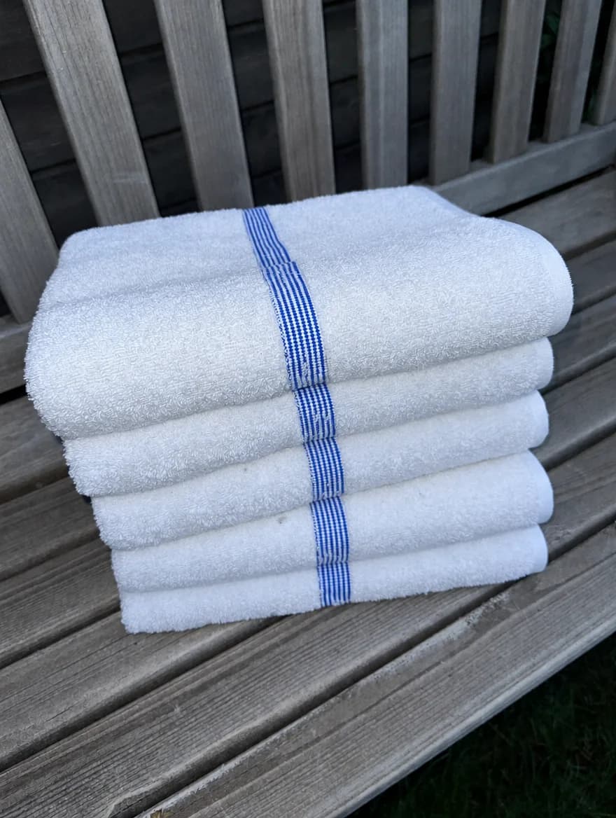 Bar Mop Towels, set of 6 in White / Blue Stripe, folded on a wooden garden bench